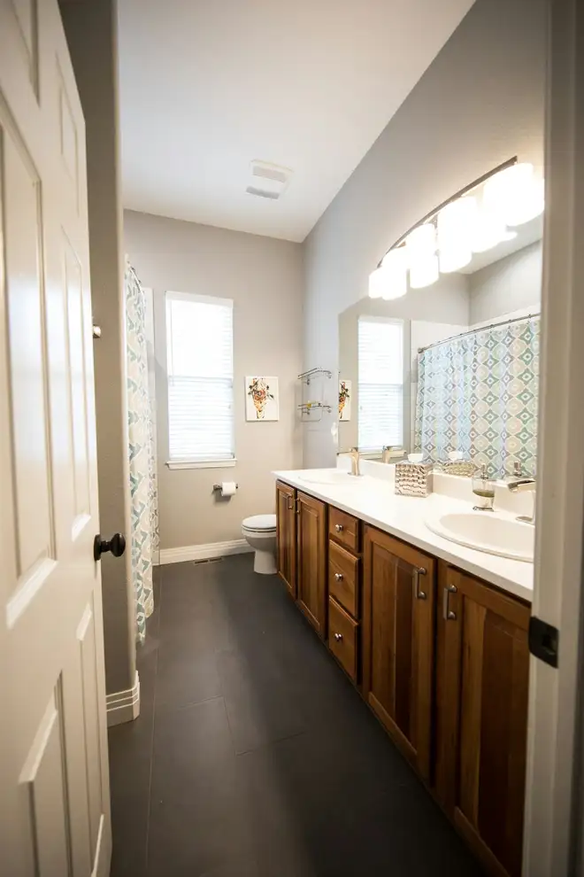 Bathroom before: a dated wooden vanity and beige walls