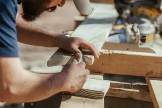 Hands fitting a piece of wood trim