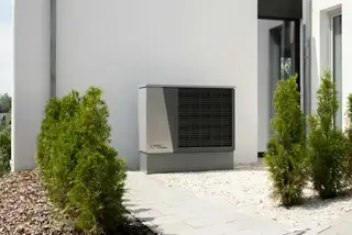 A newly installed heat pump beside a house