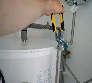 A wrench on a water heater valve